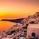 A sunset over the village of Oia on the island of Santorini, Greece